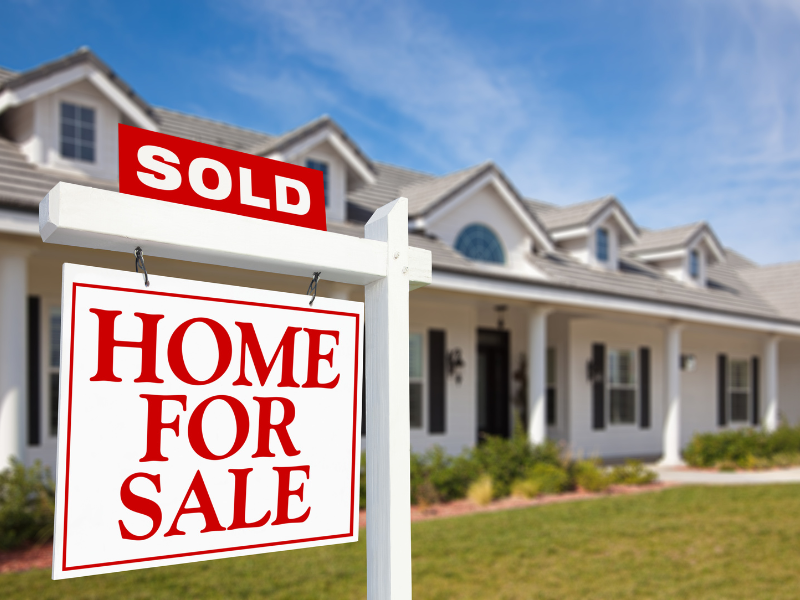Image of a sold sign in front of a house.