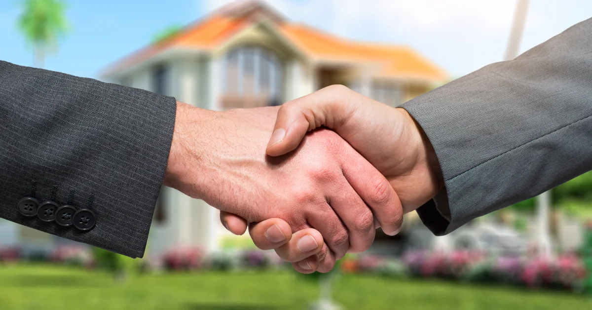 Handing over your house keys after making a mortgage contract, buying a home successfully, and becoming a home owner.