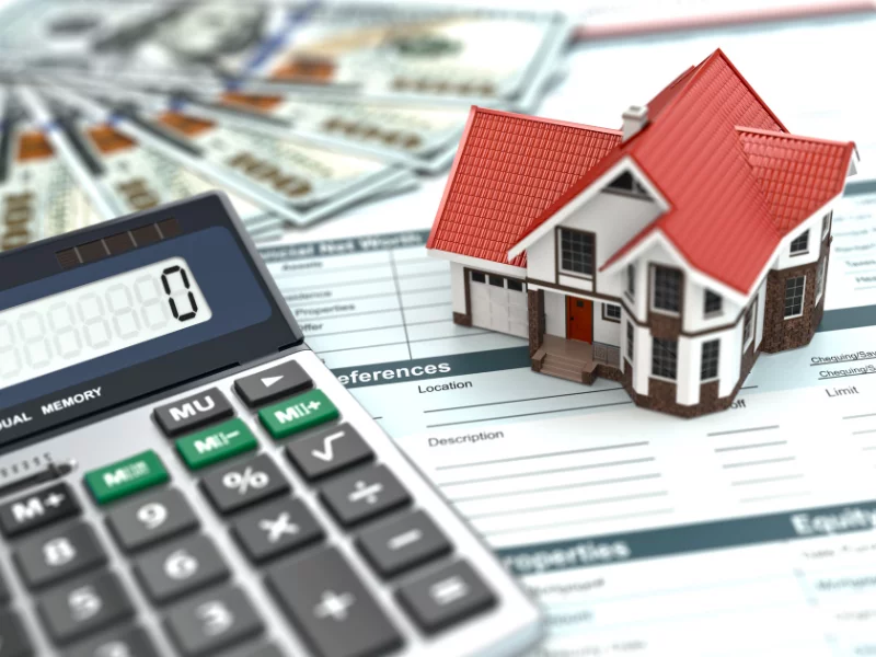 Picture of a calculator and documents, representing the costs and payment for title insurance.